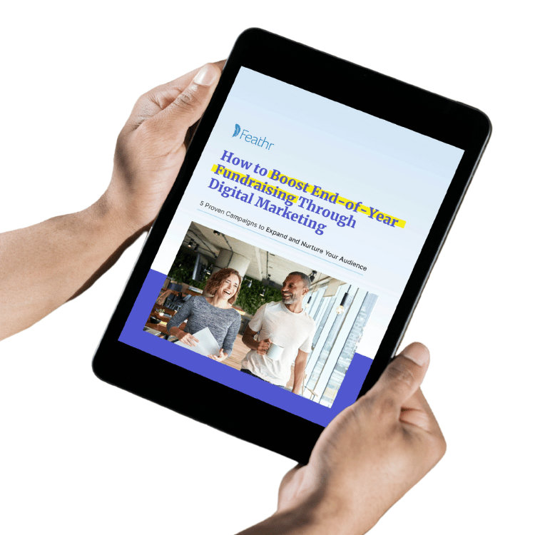 Person holding a tablet with How to Boost End-of-Year Fundraising ebook open